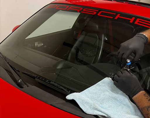 Autoglass Legend repairing red porse 911 windshield in Hamilton